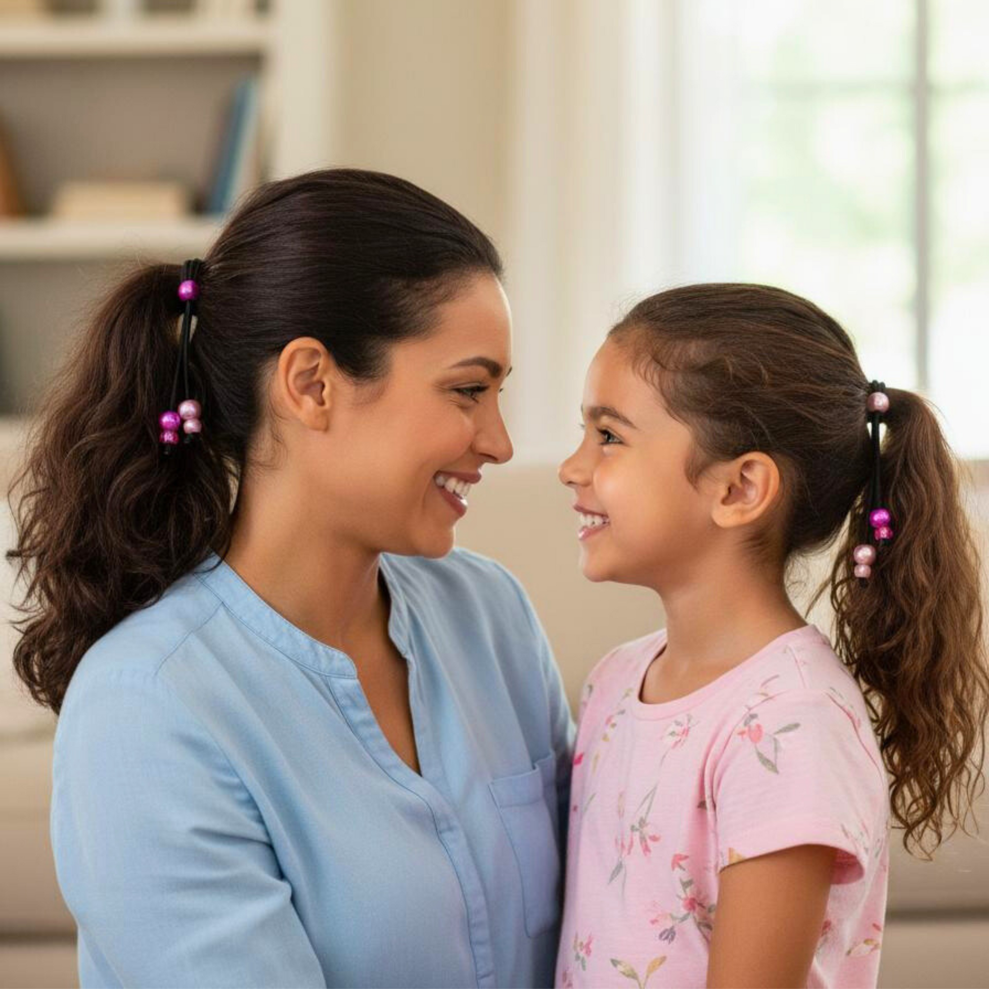 Mother and daughter smiling and wearing PonyPop™ QuickPop™ - Blush Pink hair ties