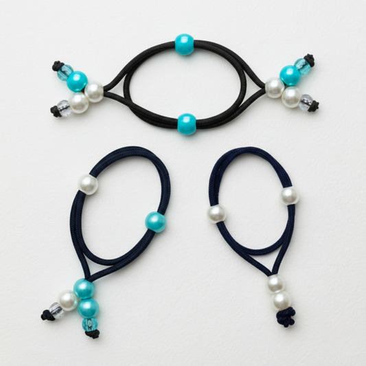 Three black hair ties with beads on a white background