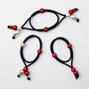 Three hair ties with colorful beads on a white background