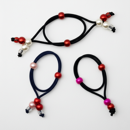 Three hair ties with colorful beads on a white background