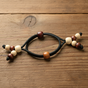 Beaded hair tie with multicolored beads on a beige background