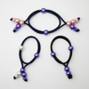 Set of four hair ties with beads on a white background