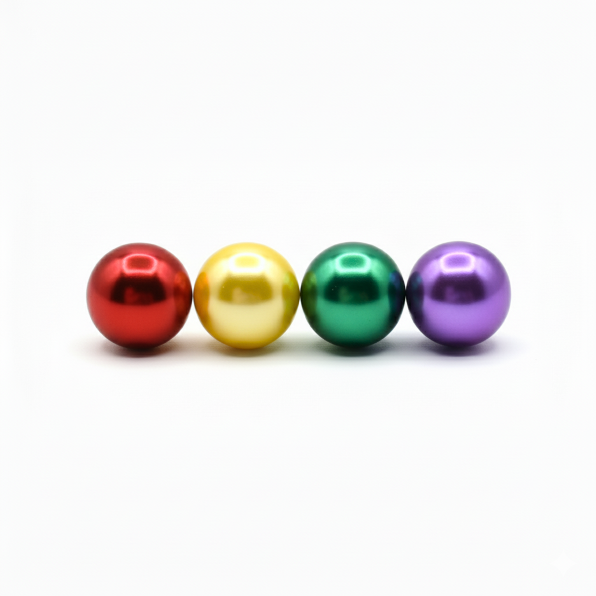 Four colorful pearls in red, yellow, green, and purple on a white background