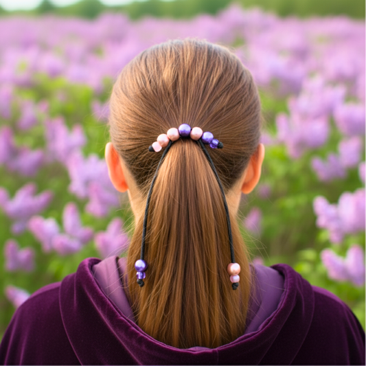 Person with a ponytail in a field of purple flowers